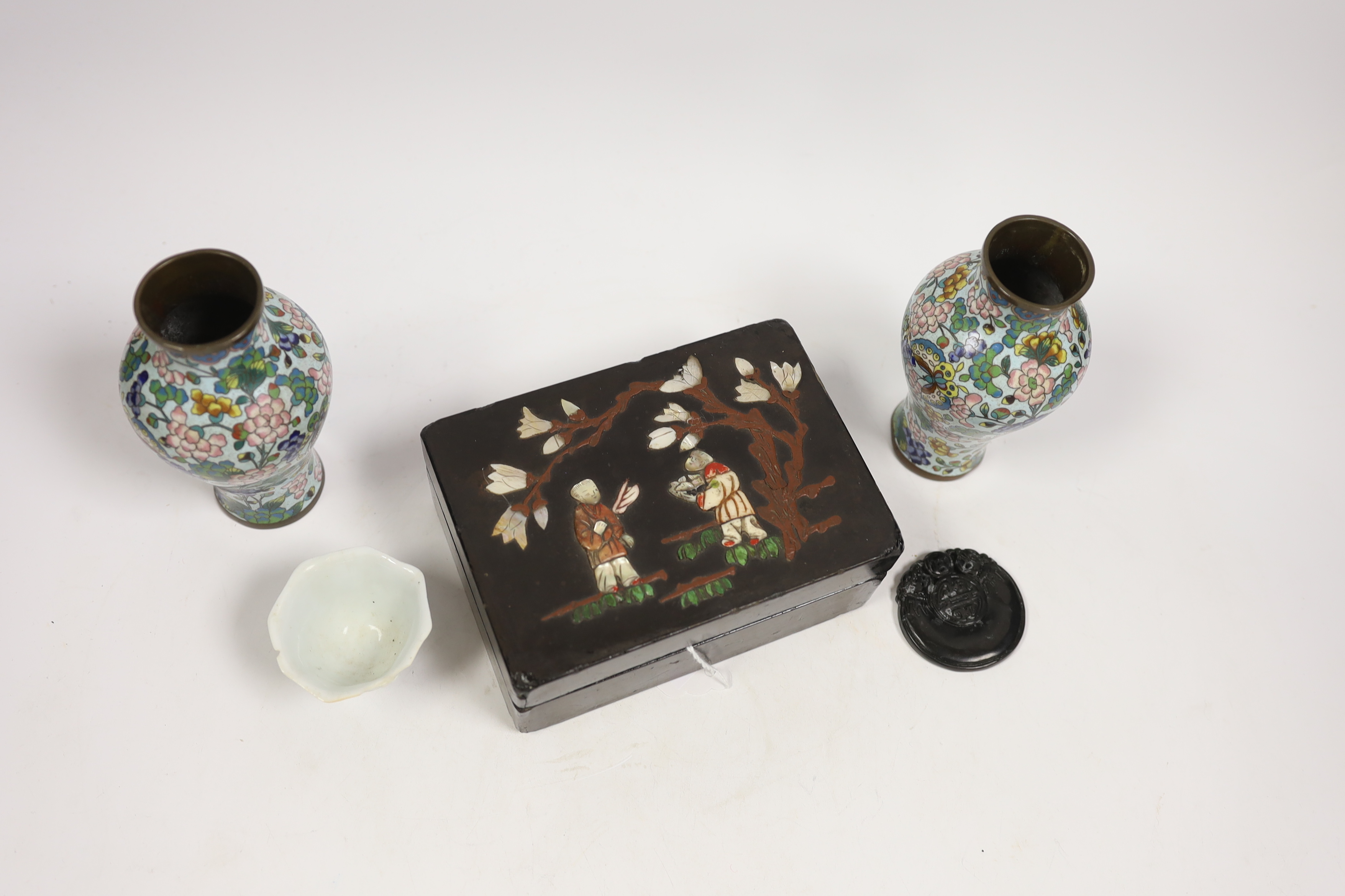 A pair of Chinese cloisonné enamel vases, 12.5cm, a lacquered box with mother of pearl inlay, a carved black stone disc, 5cm diameter, and a miniature ceramic pot (5)